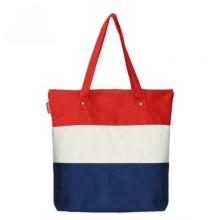 Canvas shopping bag with long carry handles and secure top button closure